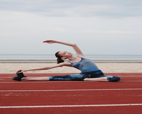 Woman doing yoga stretches outdoors in morning